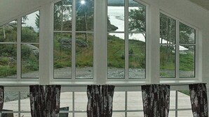 A room with large windows offering a view of a natural landscape. - Holiday Home in Vevang (Hustadvika)