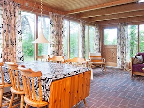 A wooden interior with a dining table, chairs, and a sofa. - 6 Person Holiday Home in Store Fuglede-by Traum (Store Fuglede)