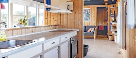 A modern kitchen with wooden accents, a built-in dishwasher, and a large window providing natural light.