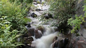A natural waterfall surrounded by rocks and greenery. - 8 Person Holiday Home in Trysil (Trysil)