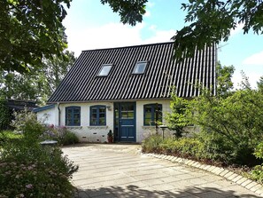 A house with a tiled roof, a front door, and a paved driveway. - 4 Star Holiday Home in Humble (Sydlangeland)