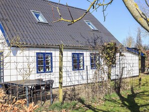 A white house with blue windows and a metal roof. - 4 Star Holiday Home in Humble (Sydlangeland)