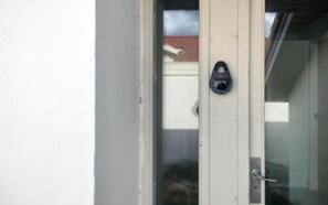 A door with a glass panel and a metal handle.