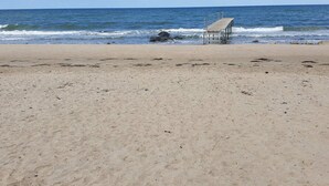 A beach with a pier extending into the ocean, sandy shore, and clear skies. - 6 Person Holiday Home in Gilleleje-by Traum (Gilleleje)