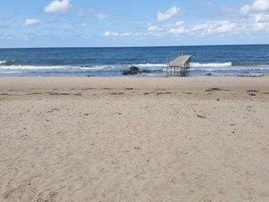 A beach with a pier extending into the ocean, sandy shore, and clear skies. - 6 Person Holiday Home in Gilleleje-by Traum (Gilleleje)