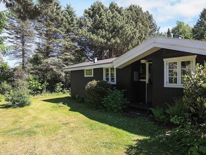 A small, dark-colored house with a sloped roof, a front door, and a 'Welcome' sign. - 6 Person Holiday Home in Gilleleje-by Traum (Gilleleje)