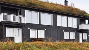 A modern two-story house with large windows and a balcony. - 11 Person Holiday Home in Oyer (Øyer)