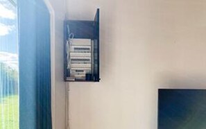 A room with a window, a wall-mounted electrical panel, and a television. - 6 Person Holiday Home in Asnaes-by Traum (Asnaes)