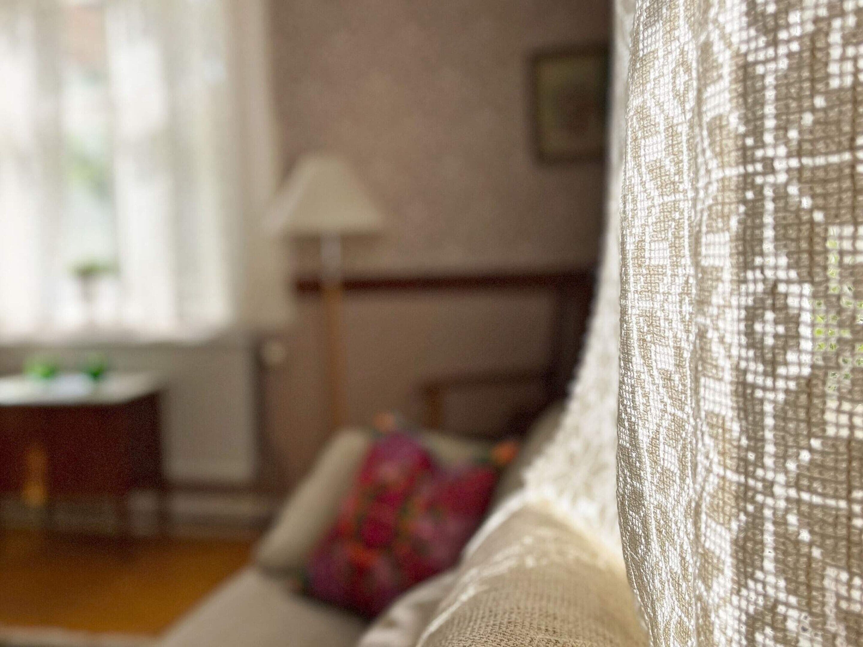 A close-up of a textured fabric, likely part of a sofa or upholstery, in a well-lit indoor setting.