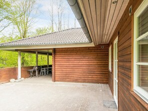 A covered patio area with a tiled roof, wooden walls, and a brick floor. - 8 Person Holiday Home in Toftlund-by Traum (Toftlund)