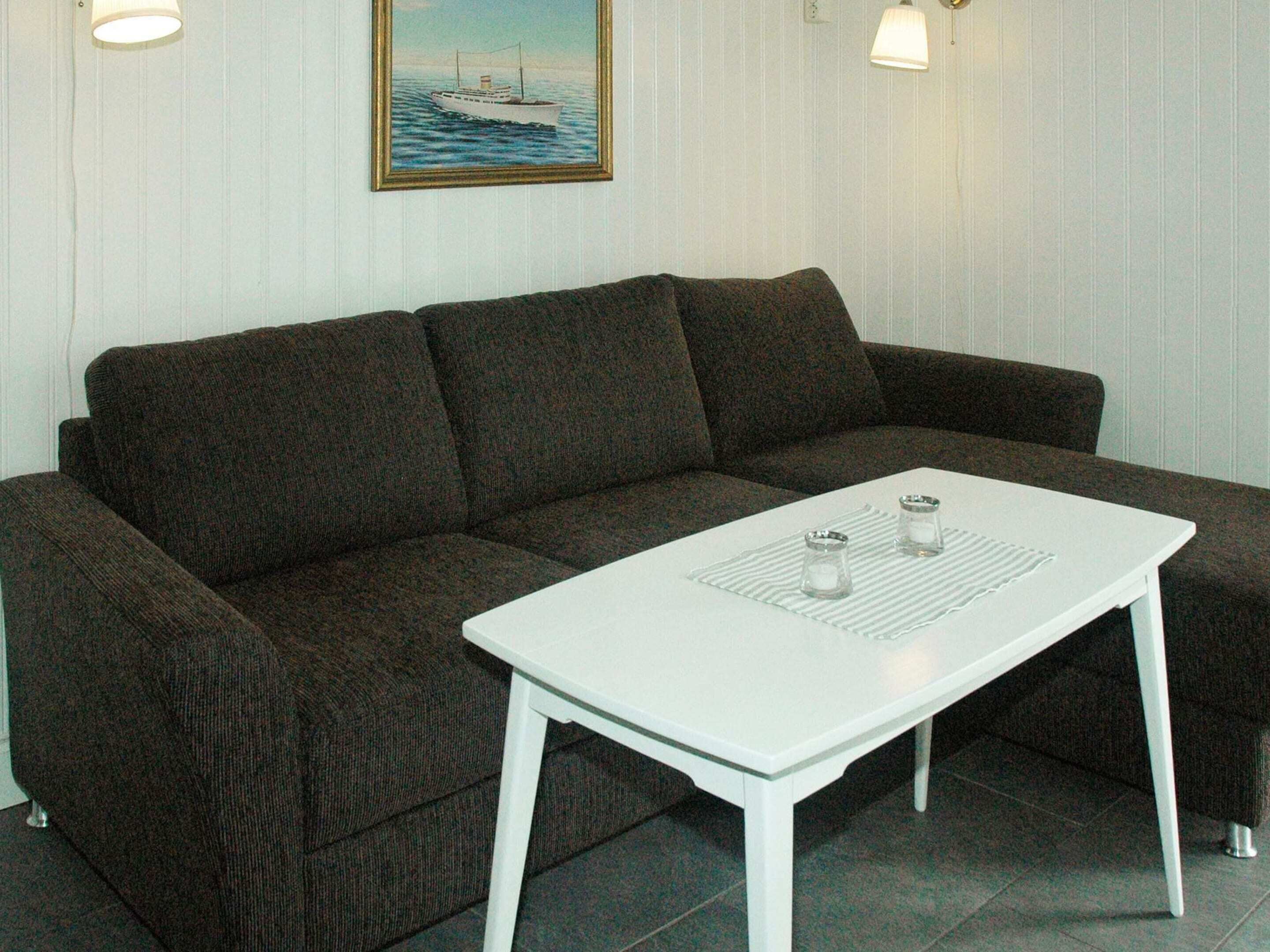 A sectional sofa with a white coffee table in front.