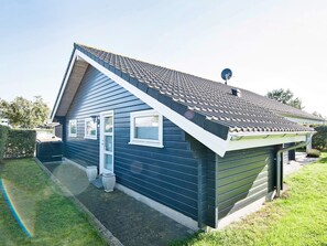 A single-story house with a sloped roof, a satellite dish, and a garage.