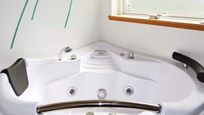 A modern bathroom with a freestanding bathtub, a window above the sink, and a wooden shelf. - Attractive Holiday Home with Whirlpool near Hadsund (Hadsund)
