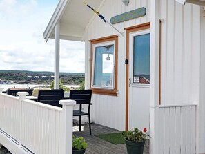 A white building with a sign reading 'DIAMOND' and a view of the sea and buildings in the background.