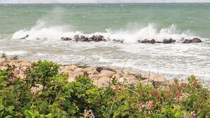 A rocky shoreline with waves crashing against the rocks.
