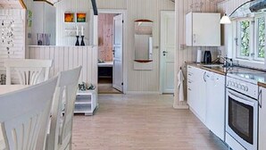 A compact kitchen with white cabinetry, a built-in oven, and a window providing natural light. - 4 Person Holiday Home in Hurup Thy-by Traum (Hurup Thy)