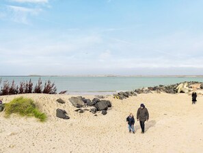 A sandy beach with rocks and a clear sky. - 6 Person Holiday Home in Thyboron (Thyborøn)