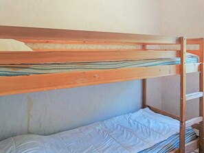 A bunk bed with a wooden frame and a lower bed with a white mattress. - 5 Person Holiday Home in Munkedal (Munkedal)