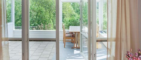 A room with a sliding glass door leading to an outdoor patio area.
