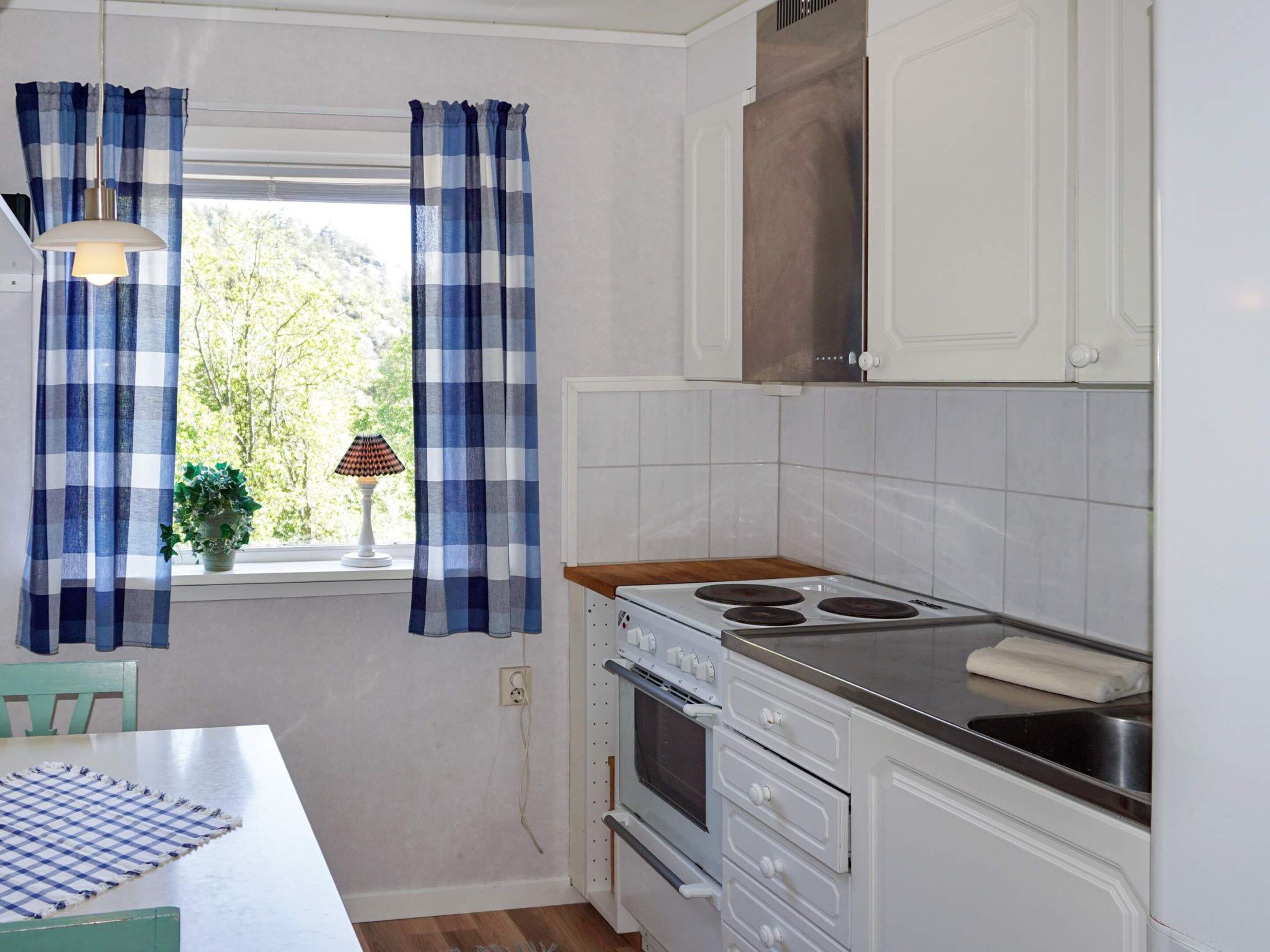 A kitchen with a stove, oven, and cabinets.