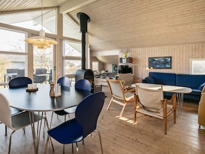 A modern interior with a dining area, seating, and a fireplace. - 6 Person Holiday Home in Ebberup (Ebberup)