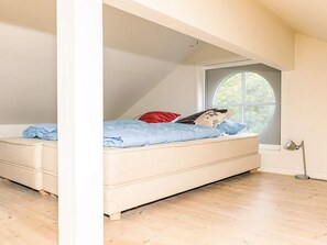 A bedroom with a single bed, a window, and a floor lamp. - 5 Star Holiday Home in Nysted (Nysted)