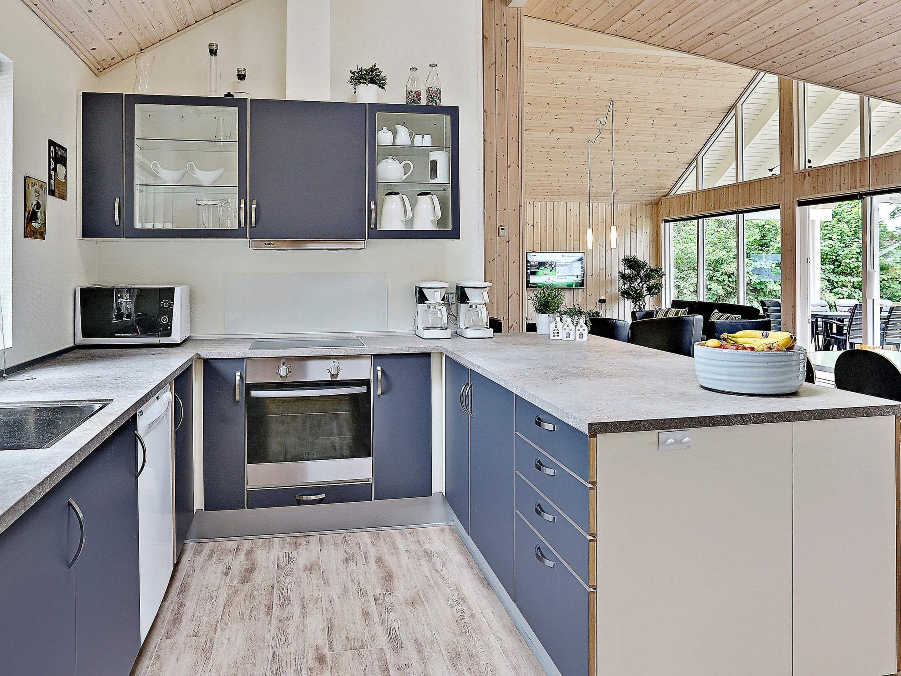A modern kitchen with a built-in oven, microwave, and coffee maker.