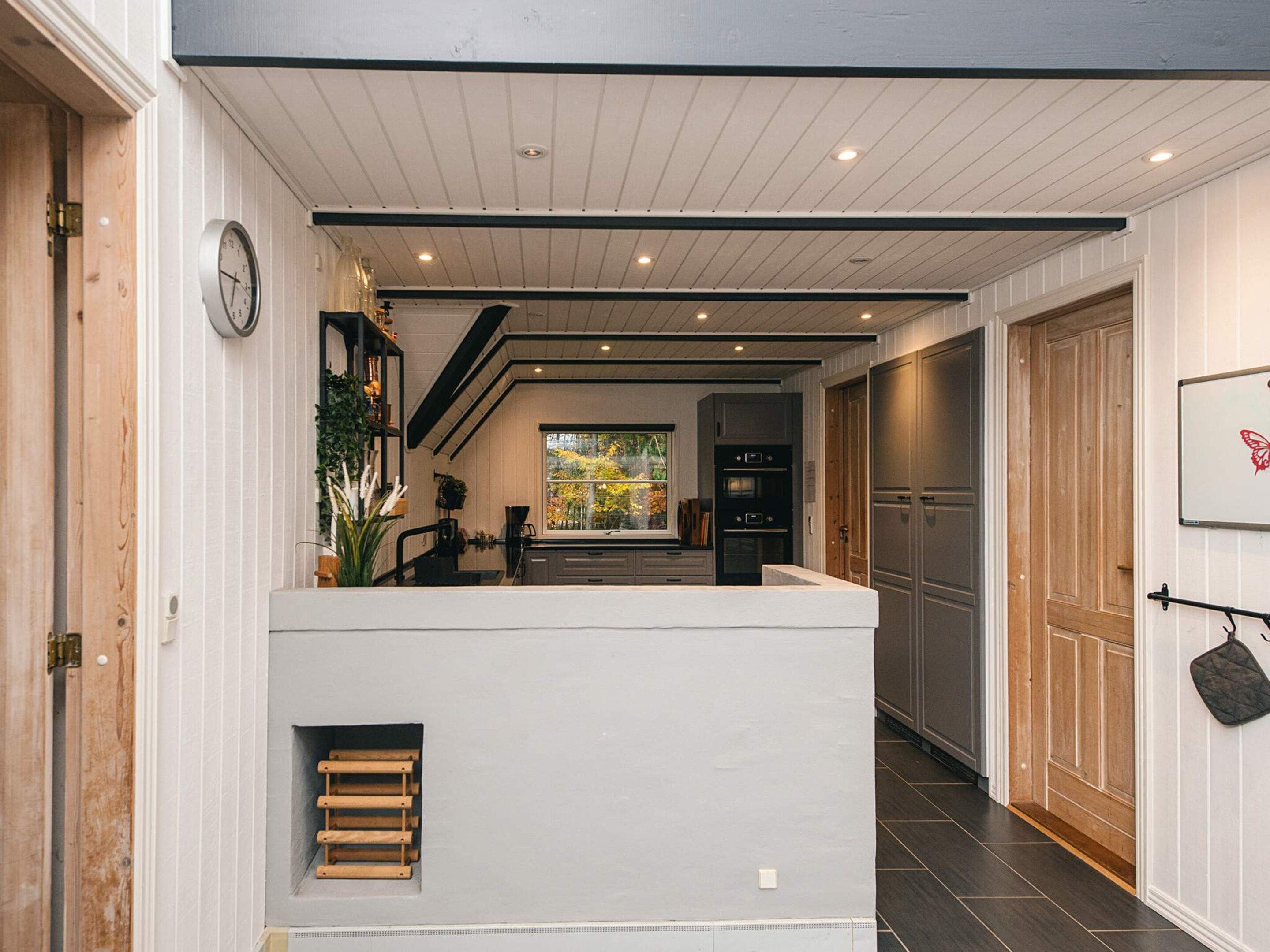 A modern kitchen with a central island, built-in appliances, and a view to the outdoors.