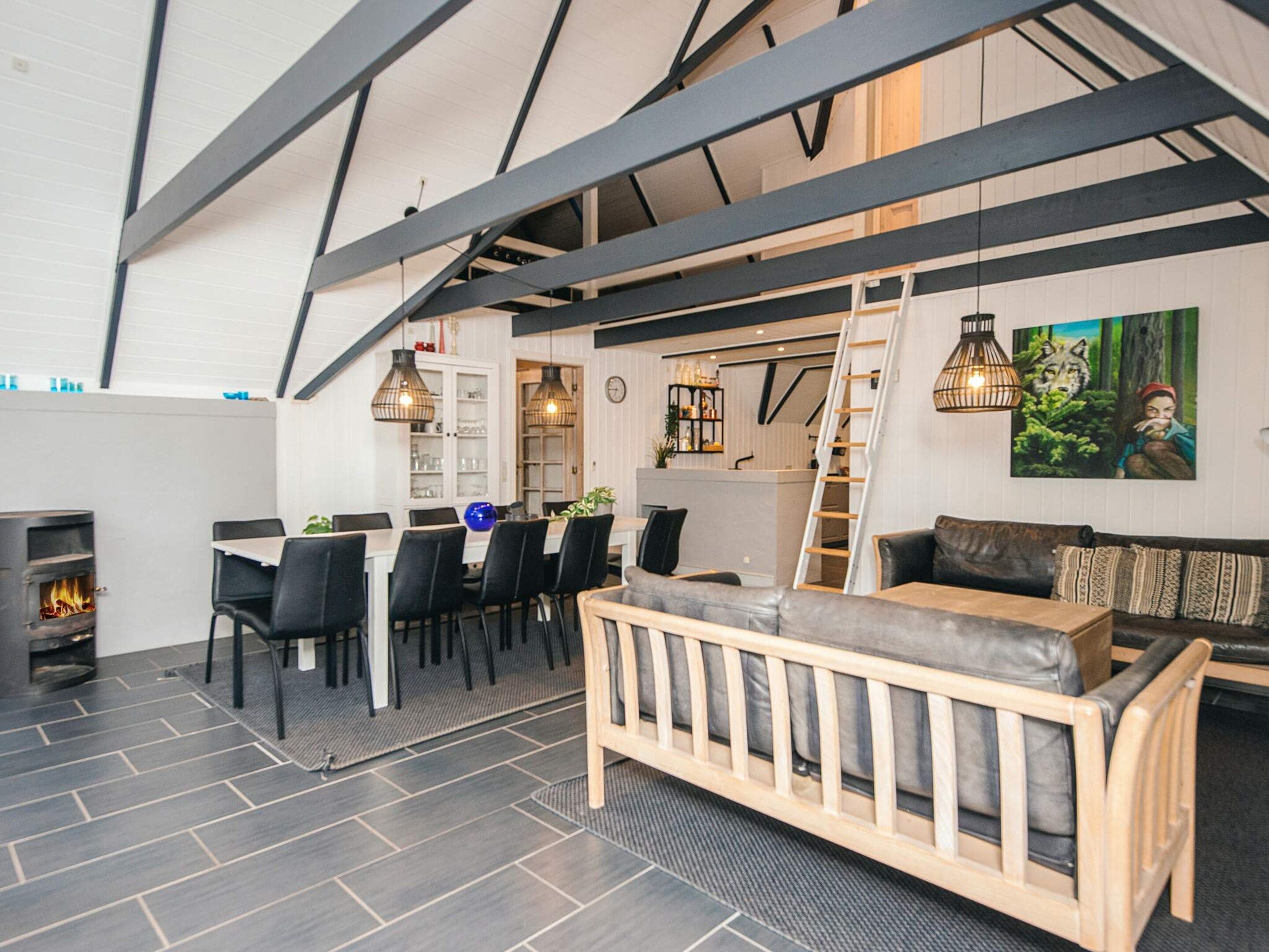 A modern interior with a dining area, a sofa, and a fireplace.