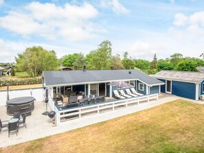 A covered outdoor patio with seating and a barbecue area. - 4 Star Holiday Home in Glesborg (Glesborg)