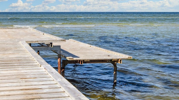 A wooden pier extending into calm waters with a clear sky above. - 4 Star Holiday Home in Glesborg (Glesborg)