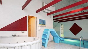 A bathroom with a large bathtub, a shower area, and a small window. - 12 Person Holiday Home in Ulfborg (Ulfborg)