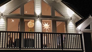 A house with a gabled roof and multiple windows, some with decorative star-shaped cutouts. - Holiday Home in BrattvÃ¥g (Ålesund)