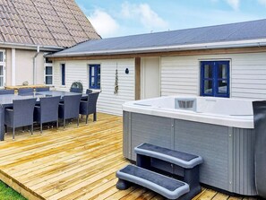 A deck with outdoor furniture and a hot tub. - 4 Star Holiday Home in Vestervig (Vestervig)