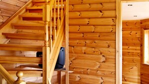 A wooden staircase with a handrail and a door leading to another room. - 10 Person Holiday Home in Bygstad (Sunnfjord)