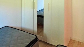 A bedroom with a bed, a wardrobe, and a mirror. - Tranquil Holiday Home in Hals near Beach (Hals)