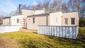 A modular RV with a white exterior, a chimney, and a ladder leading to the roof. - 4 Star Holiday Home in Ebeltoft (Ebeltoft)