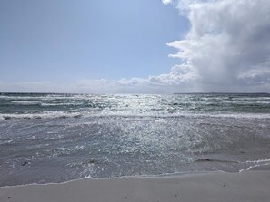 A beach with waves and a cloudy sky. - 4 Star Holiday Home in Ebeltoft (Ebeltoft)