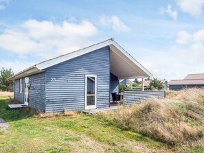 A single-story house with a gabled roof, number 21, featuring a covered porch area.