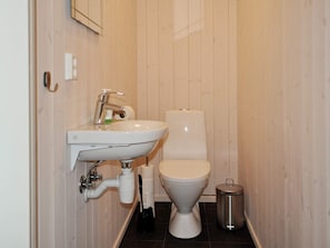A small bathroom with a white sink, toilet, and a trash can. - 4 Star Holiday Home in Oyer (Øyer)