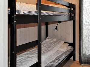 A bunk bed with two levels, each with a mattress and pillows. - 4 Star Holiday Home in Oyer (Øyer)