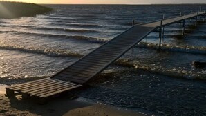 A wooden pier extending into the water with a bench at the end. - 4 Star Holiday Home in Ulfborg (Ulfborg)