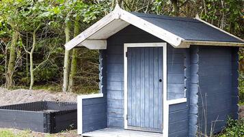 A small, single-room cabin with a sloped roof and a door.