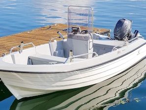 A white motorboat docked at a wooden pier. - 4 Person Holiday Home in Bjoa (Vindafjord)