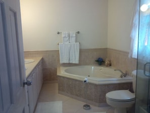 A bathroom with a bathtub, toilet, and sink.