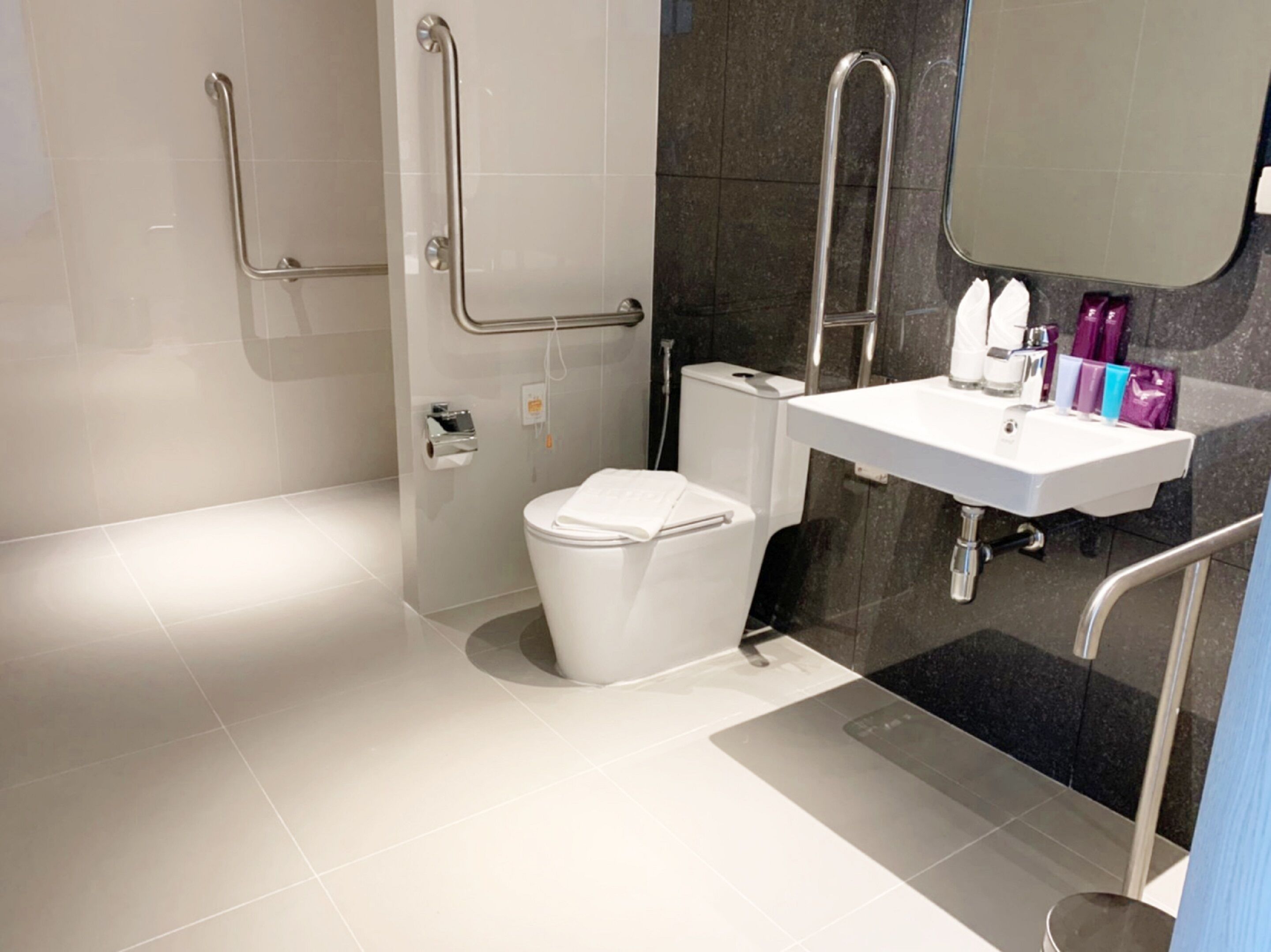 A modern bathroom with a toilet, bidet, and sink.