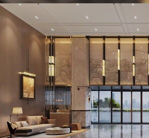 A modern lobby with a sofa, a coffee table, and a framed artwork on the wall. - Five Rams City Hotel (Guangzhou)