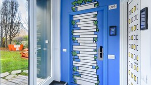 A door with a blue frame, a glass door, and a keypad lock. - Residence Cimarosa (Milan)