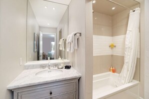Combined shower/tub, hair dryer, soap, shampoo