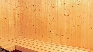 A wooden sauna room with benches and a bench with a storage compartment.